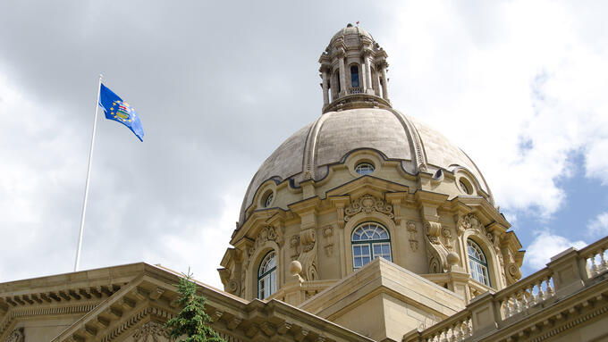 Alberta Legislature dome with blue provincial flag