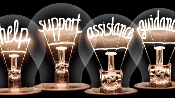 Lightbulbs with the words Help, support , assistance and guidance written in the filaments