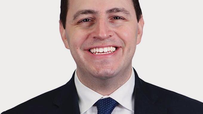 Portrait  of Alberta Education minister wearing a suit and blue tie