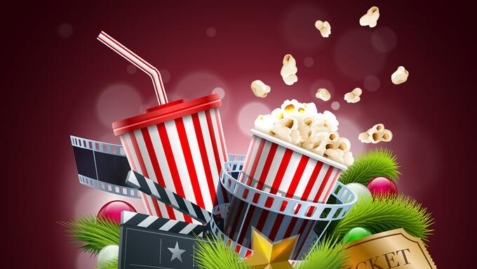 Popcorn, movie camera and ticket in front of a red curtain