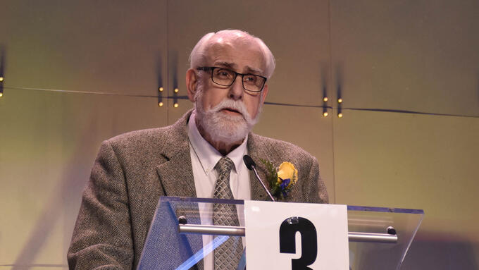 ATA suporter, Richard Rand stands at a podium at a past ARA