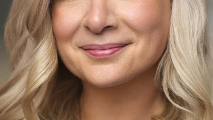 Bright smile and eyes on a profile photo of a blonde woman.