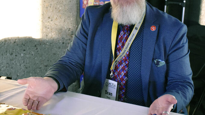 Sean Brown sits at a table with bargaining chips