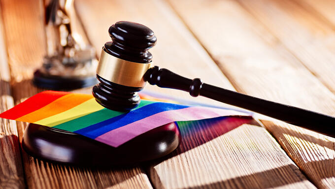 A gavel resting on a pride flag