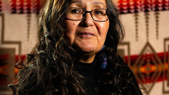 Indigenous women seated in front of a Pendleton Blanket