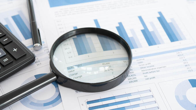 Magnifying Glass on papers with charts