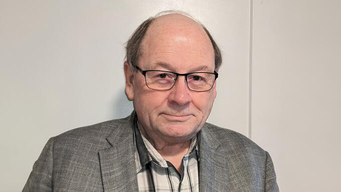Portrait of  late middle age balding man in blazer