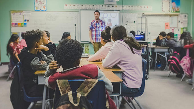 Students sitting in a desk cluster in a classroom