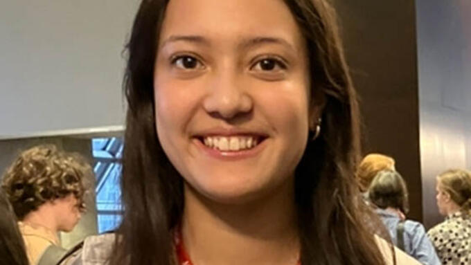 Young women with red lanyard smiling