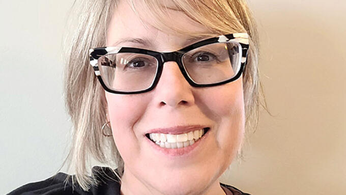 Selfie of blond women with black cat framed glasses