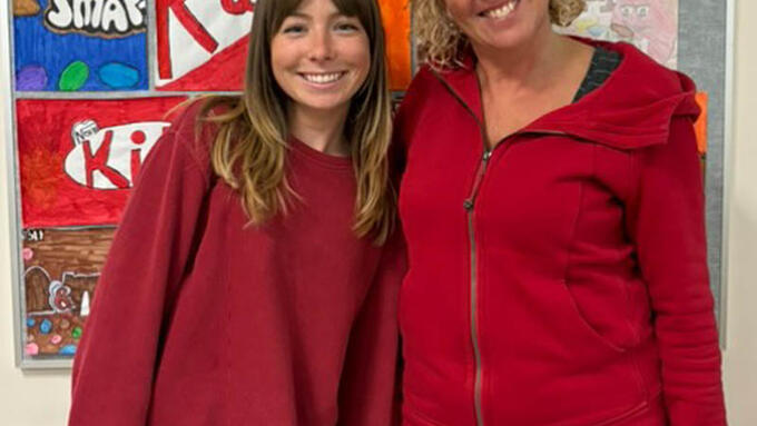 Two female teachers wearing read sweatshirts