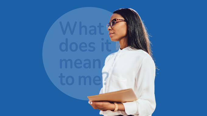 Women wearing glasses and white blouse holding a book