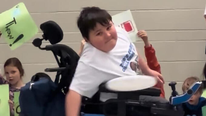 A student throws a frisbee achieving a world record
