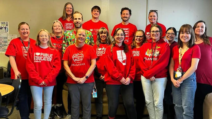 Teachers stand in their red t-shirts