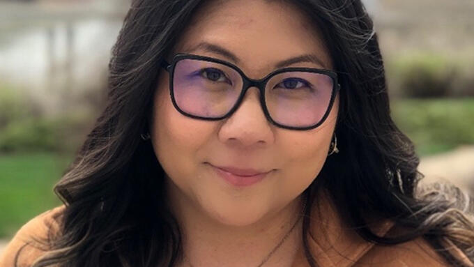 Portrait in river valley of women wearing glasses and brown blazer