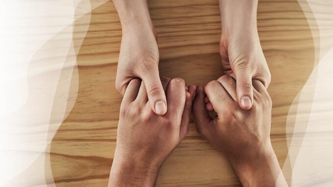 Holding hands over tabletop
