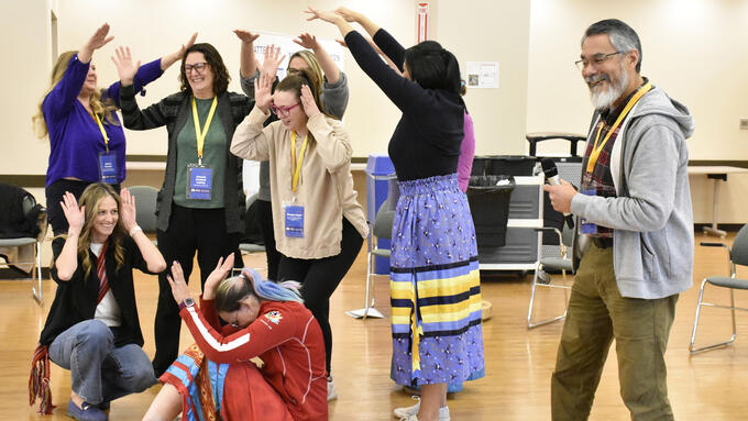 Group of participants do a group dance