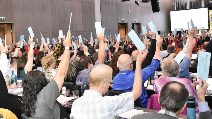 ARA delegates raise their hands in a vote