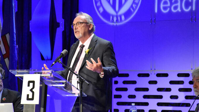 Man in suit speaks at ARA podium