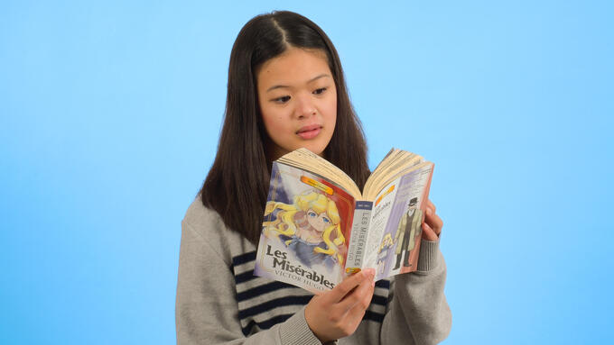Portrait shot of a pre-teen girl reading manga. 