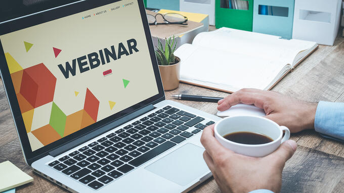 Laptop with title screen of a webinar