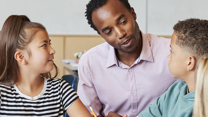 Teacher seated with students