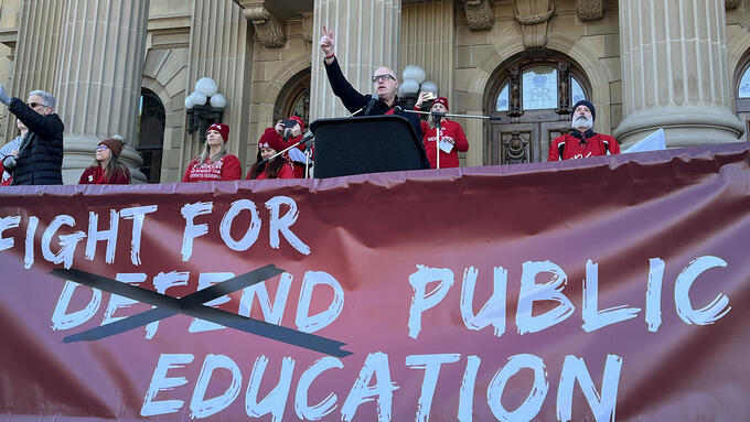 Jason Schilling stands in front of a crowd at a rally