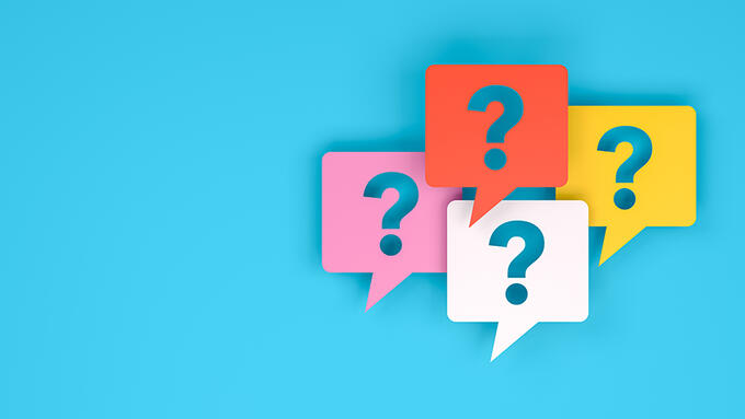 four colourful speech bubbles with question marks