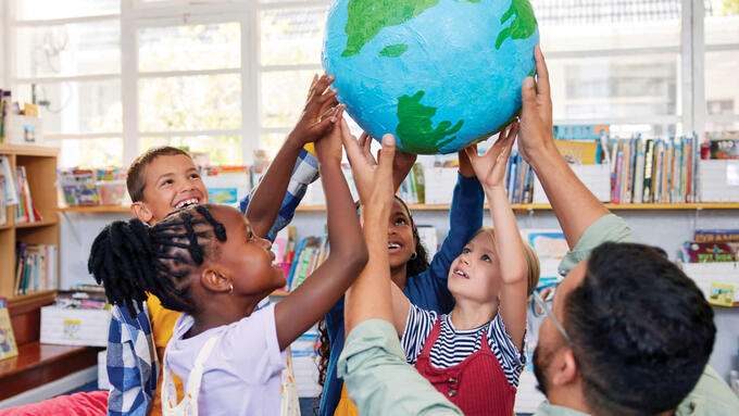 Group of grad 2 students holding up a globe