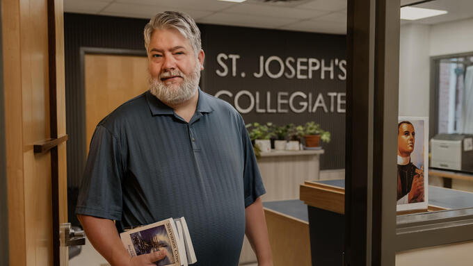 Ben Galeski wears a grey shirt as he steps outside of the school office