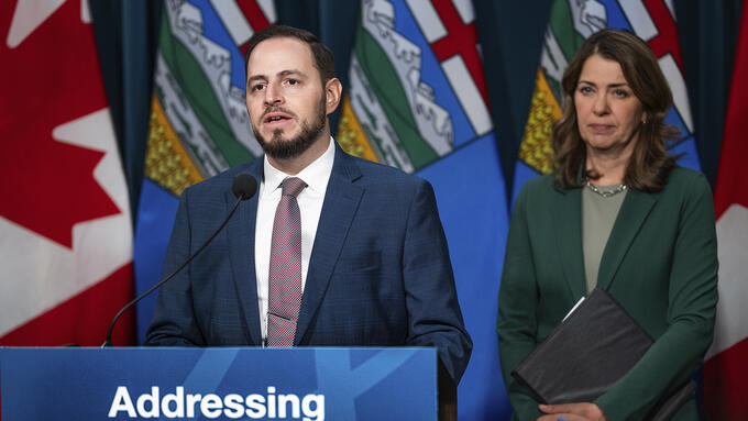 Alberta's premier and minister of Education and Childcare at a press conference