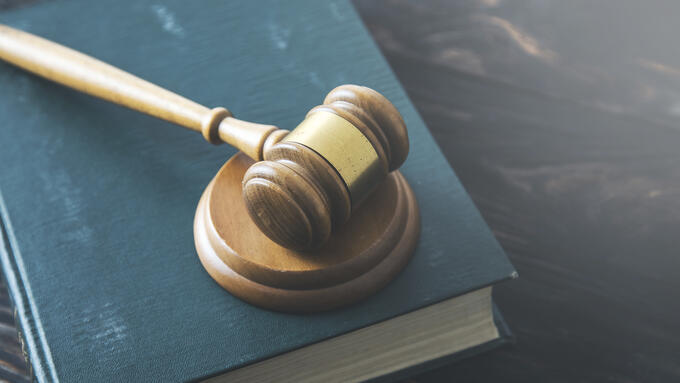 A gavel resting on a book