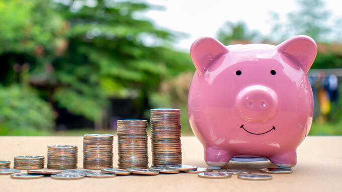 Piggy bank with stack of coins next to it