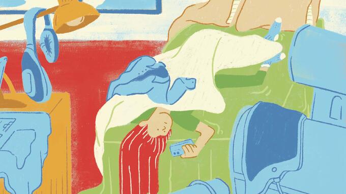 Kid laying on bed looking at phone