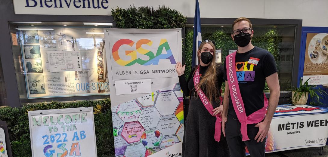 Two people standing in front of a GSA display
