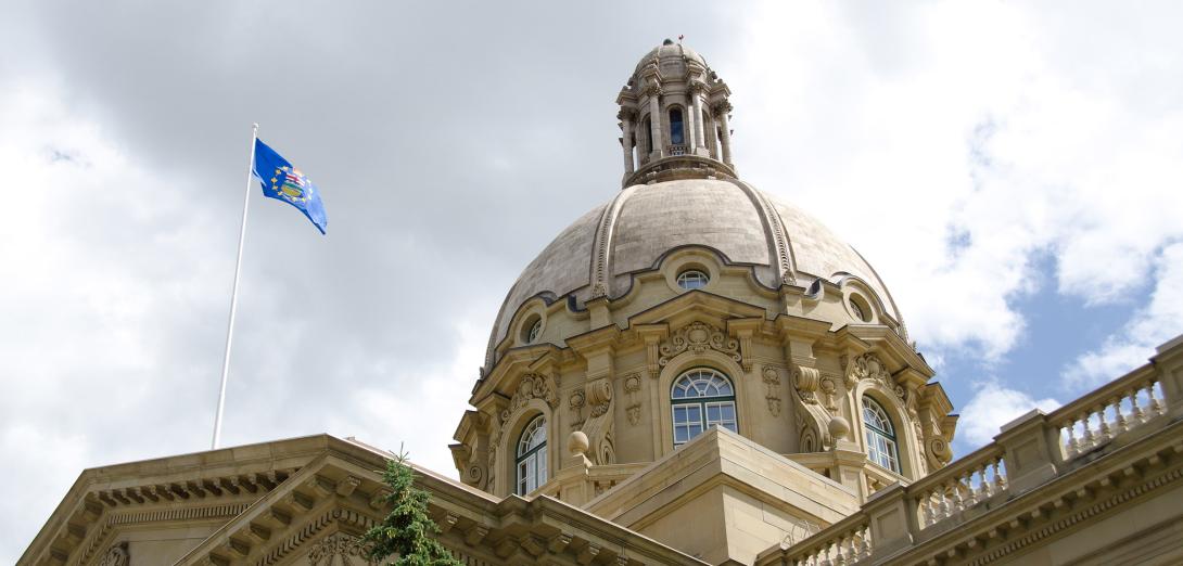 Alberta Legislature dome with blue provincial flag
