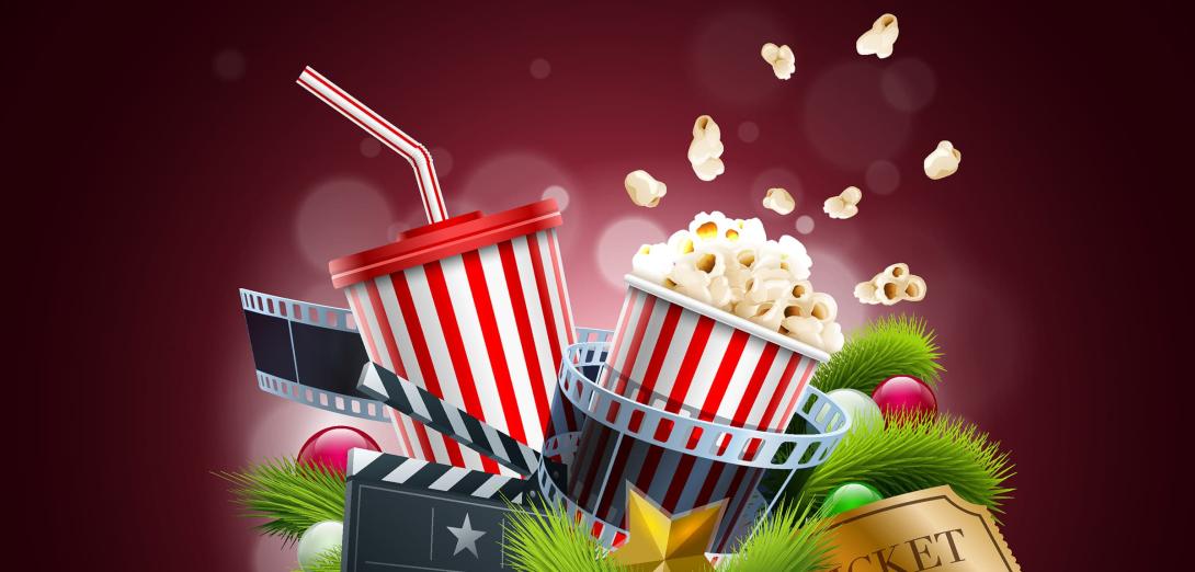 Popcorn, movie camera and ticket in front of a red curtain