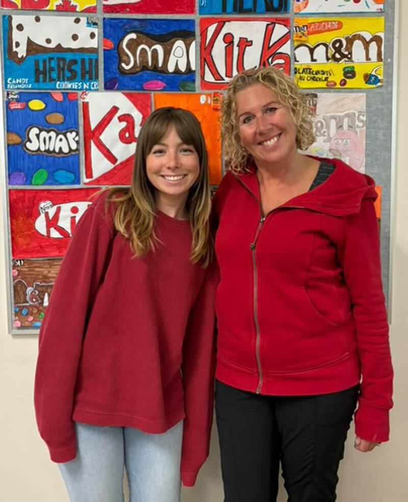 Two female teachers wearing read sweatshirts