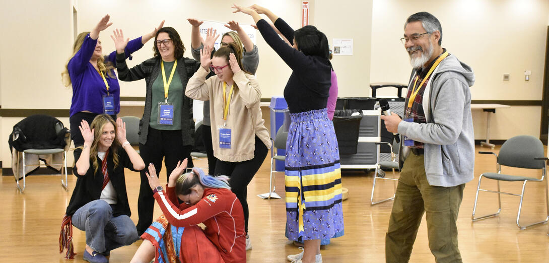 Group of participants do a group dance
