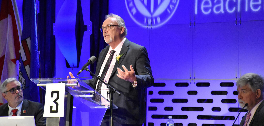 Man in suit speaks at ARA podium
