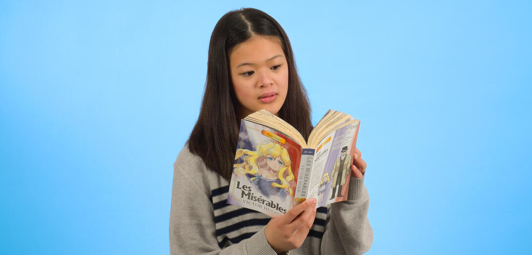Portrait shot of a pre-teen girl reading manga. 